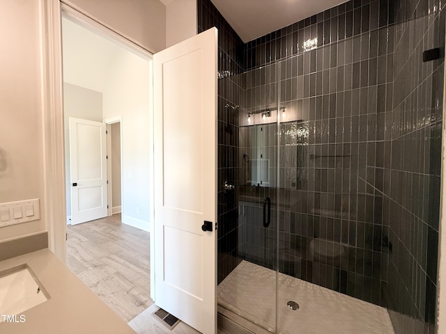 5820 Shawood Dr, Raleigh, NC 27609 - bathroom featuring a shower stall, wood finished floors, and a sink