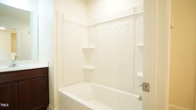 bathroom featuring vanity and  shower combination