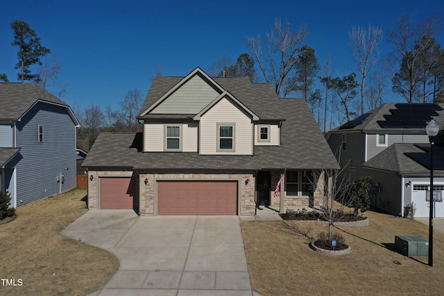 view of front of house featuring a garage and a front lawn