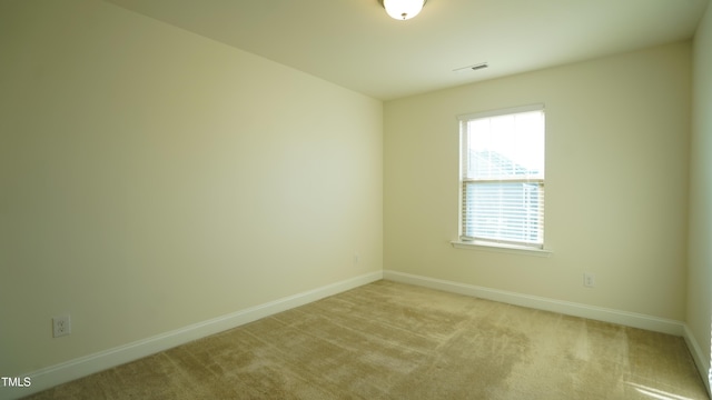 empty room featuring light colored carpet