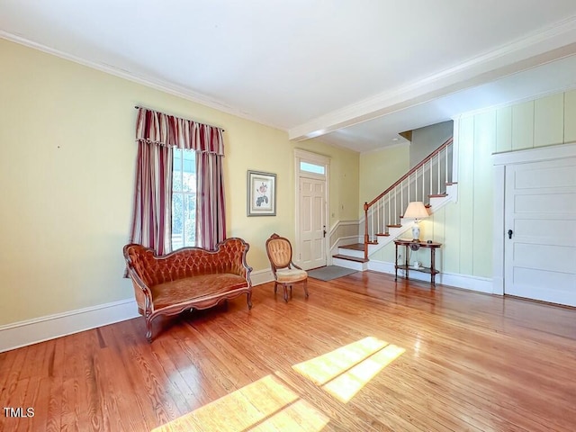 sitting room featuring crown molding and light hardwood / wood-style floors