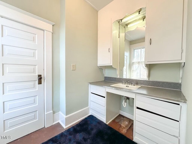 interior space featuring sink and white cabinets