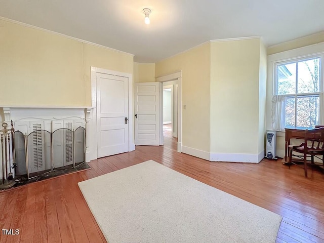 interior space featuring hardwood / wood-style flooring and crown molding