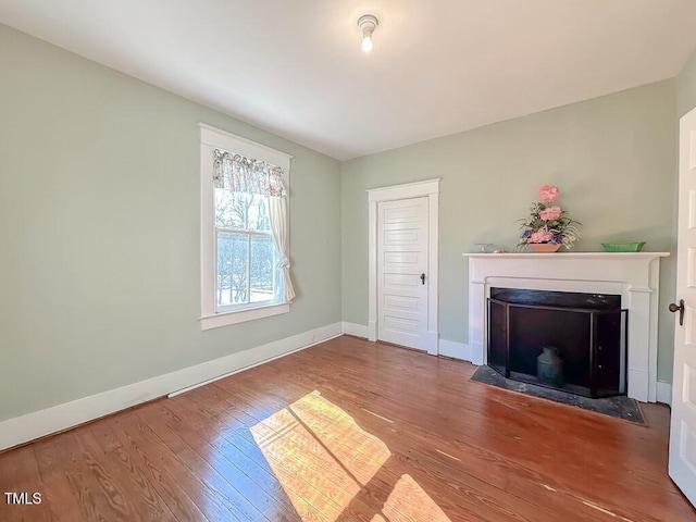 unfurnished living room with hardwood / wood-style flooring