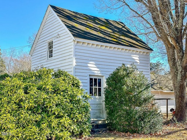 view of side of home featuring an outbuilding