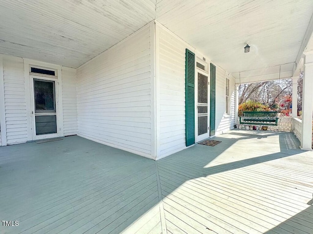 wooden terrace with a porch