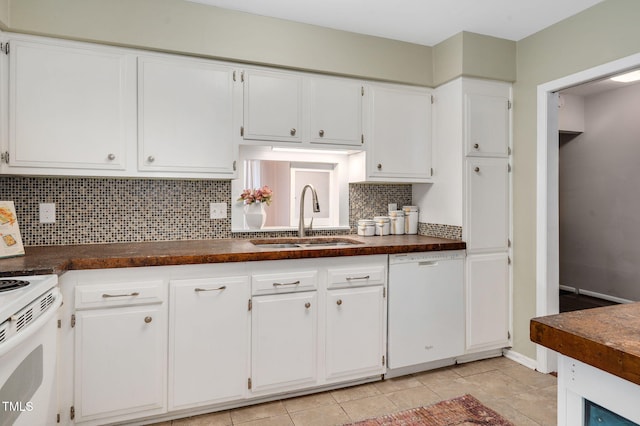 kitchen with sink, tasteful backsplash, light tile patterned floors, white appliances, and white cabinets