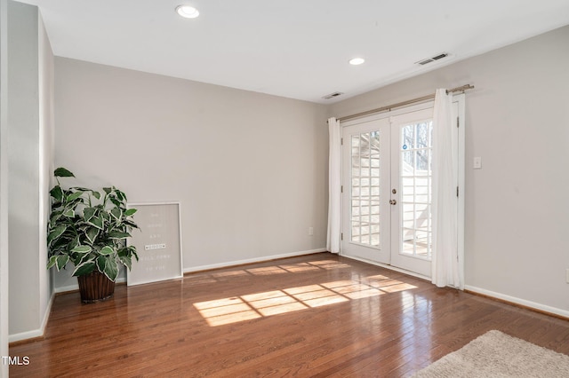 empty room with wood-type flooring and french doors