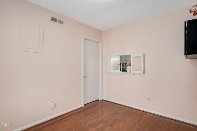 unfurnished room with hardwood / wood-style flooring