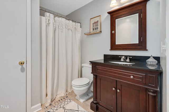 bathroom featuring vanity, tile patterned floors, and toilet