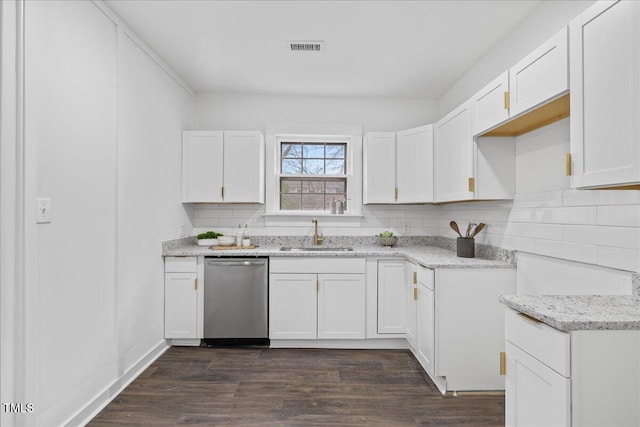 kitchen featuring light stone counters, stainless steel dishwasher, sink, and white cabinets