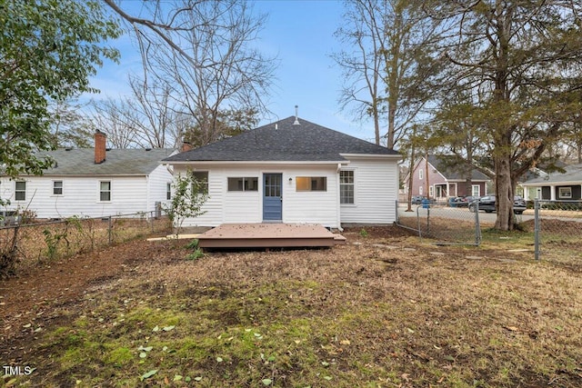 back of house with a wooden deck and a lawn