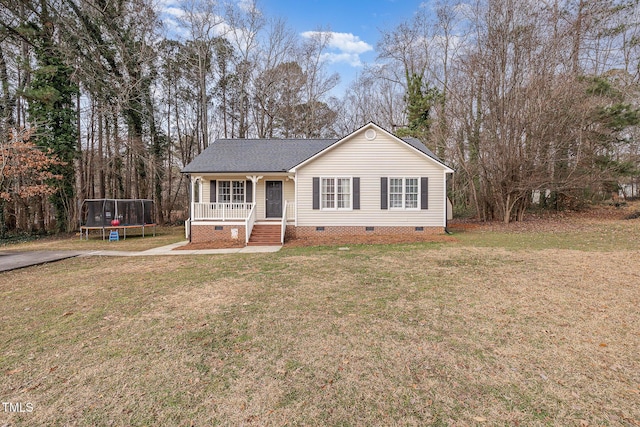 view of front of property with covered porch, a trampoline, and a front yard