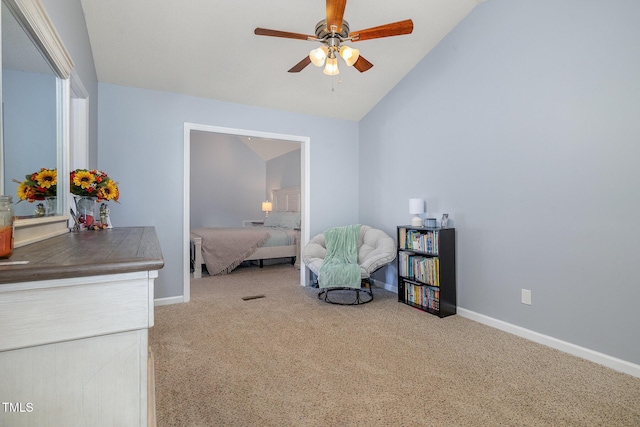 living area featuring lofted ceiling, carpet floors, and ceiling fan