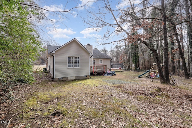 exterior space featuring a wooden deck and a playground