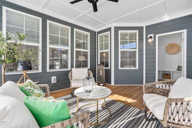 sunroom with coffered ceiling and ceiling fan