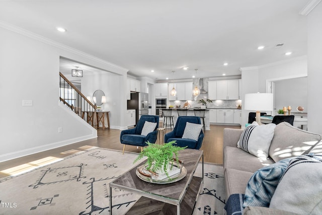 living room featuring ornamental molding and wood-type flooring