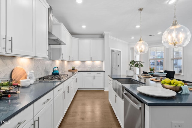 kitchen with white cabinetry, decorative light fixtures, and stainless steel appliances