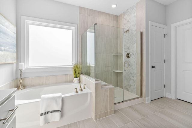 bathroom with vanity and plus walk in shower