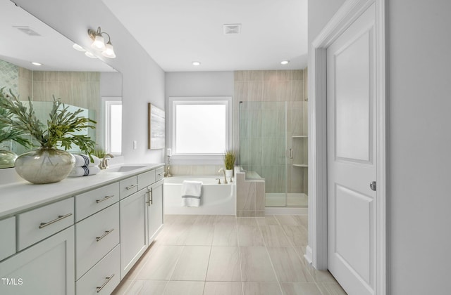 bathroom with tile patterned floors, vanity, and plus walk in shower