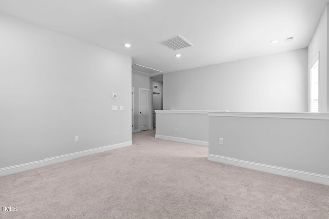 unfurnished room featuring light carpet