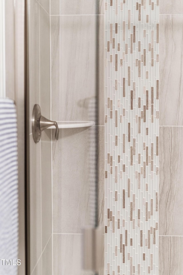 bathroom featuring a shower with shower door