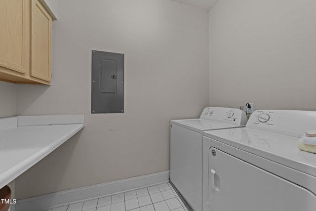 washroom featuring light tile patterned flooring, cabinets, electric panel, and washer and dryer