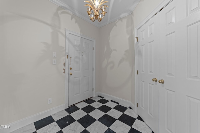 entrance foyer with ornamental molding and a notable chandelier