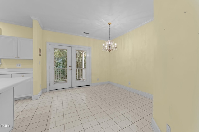 unfurnished dining area featuring light tile patterned floors, crown molding, french doors, and a chandelier