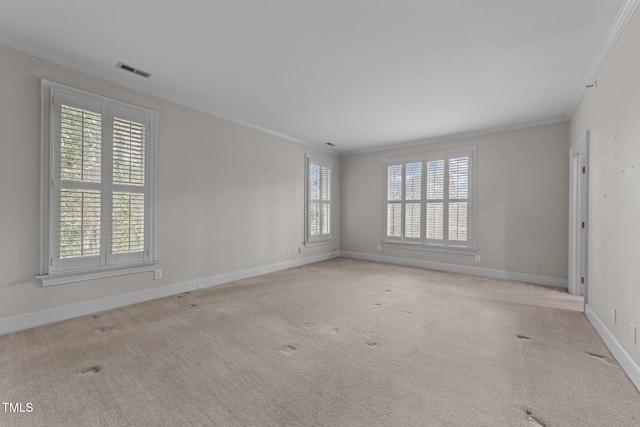 carpeted spare room featuring crown molding