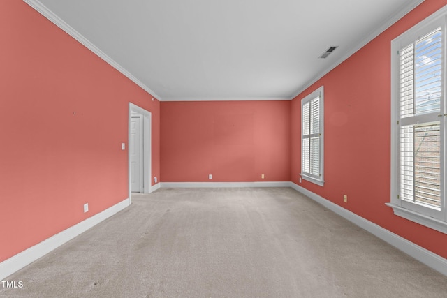 empty room featuring light colored carpet and ornamental molding