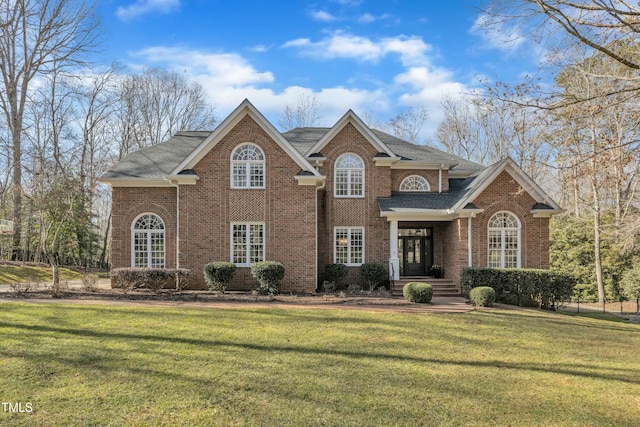 view of property featuring a front lawn