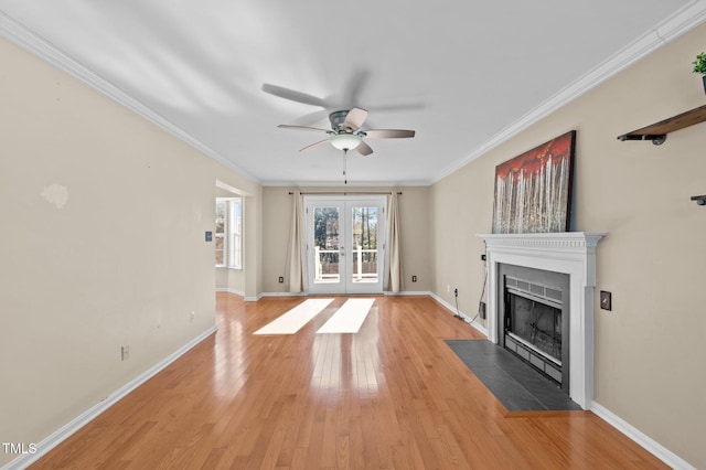 unfurnished living room featuring french doors, ornamental molding, ceiling fan, and light hardwood / wood-style flooring