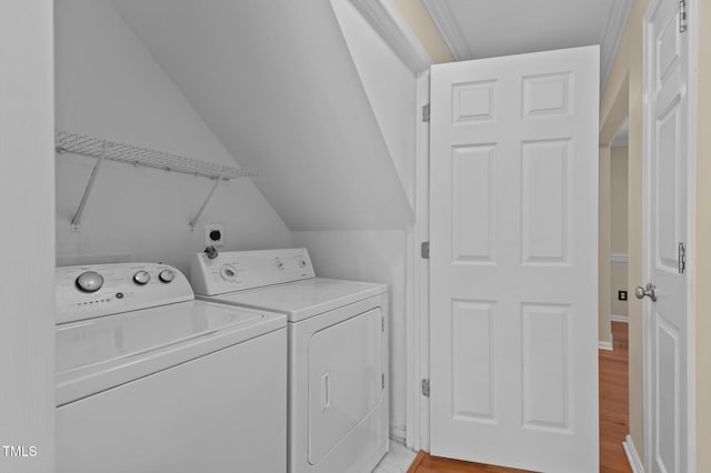 laundry area featuring light hardwood / wood-style floors and washing machine and dryer