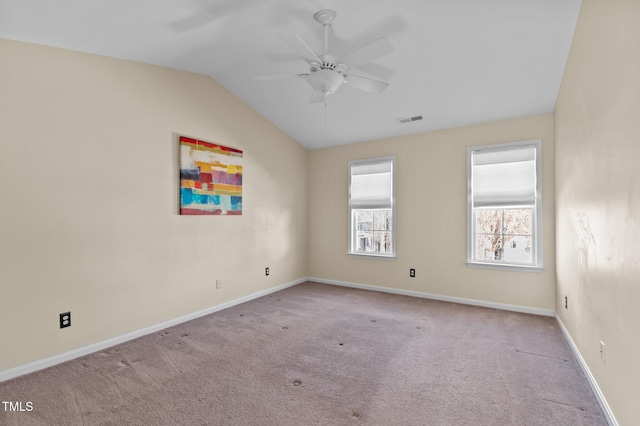 carpeted empty room featuring vaulted ceiling and ceiling fan