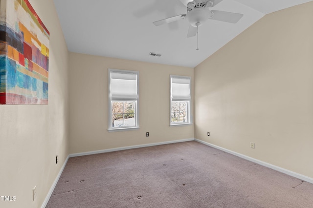 carpeted empty room featuring vaulted ceiling and ceiling fan