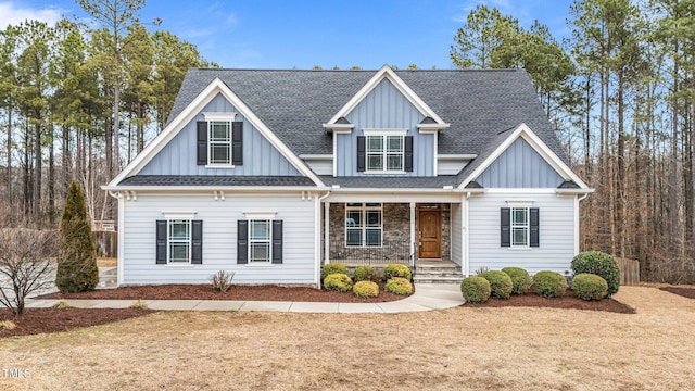 craftsman-style house with a porch and a front lawn