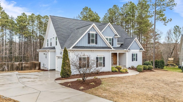 craftsman-style home featuring a garage and a front lawn