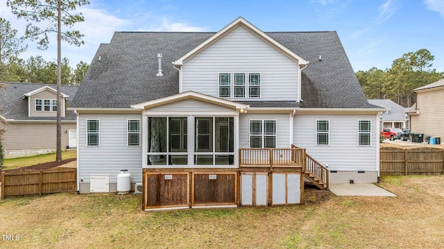 back of house featuring a yard and a sunroom