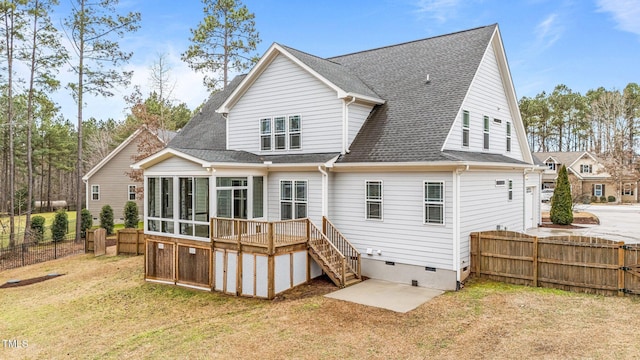 rear view of property featuring a yard and a sunroom