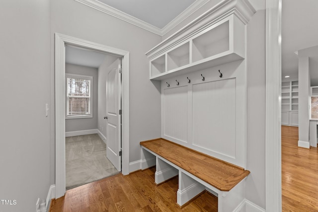 mudroom with crown molding and light wood-type flooring