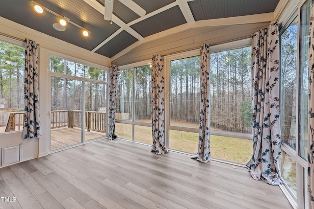 unfurnished sunroom with lofted ceiling