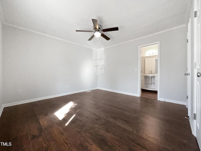 empty room with crown molding, dark wood-type flooring, and ceiling fan