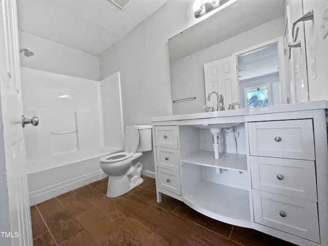 bathroom with hardwood / wood-style floors, shower / bathtub combination, and toilet