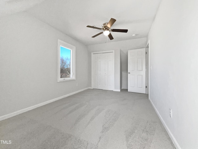 unfurnished bedroom featuring carpet, ceiling fan, and a closet