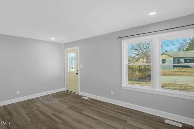 spare room featuring dark hardwood / wood-style flooring