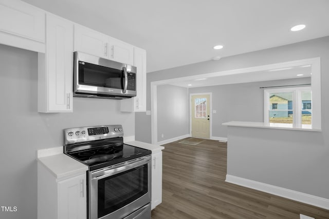 kitchen featuring white cabinetry, appliances with stainless steel finishes, and dark hardwood / wood-style flooring