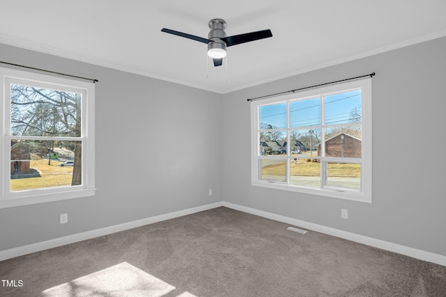 carpeted spare room featuring ornamental molding and ceiling fan