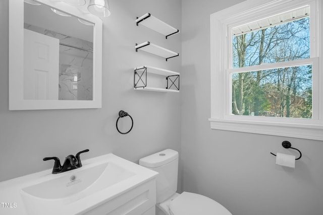 bathroom with sink, toilet, and a healthy amount of sunlight