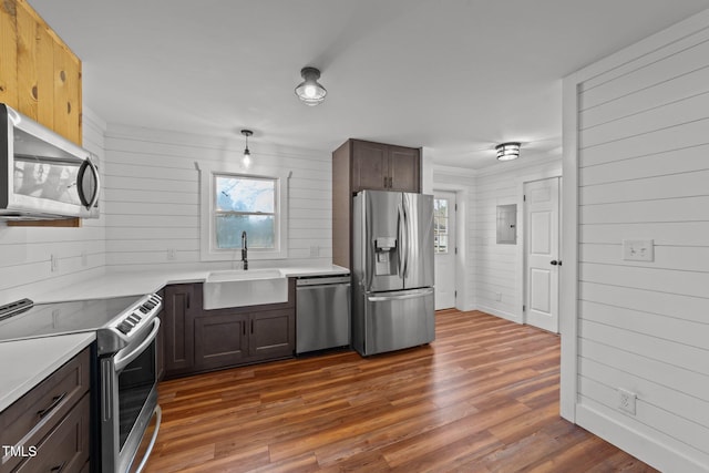 kitchen featuring appliances with stainless steel finishes, dark hardwood / wood-style flooring, sink, and plenty of natural light